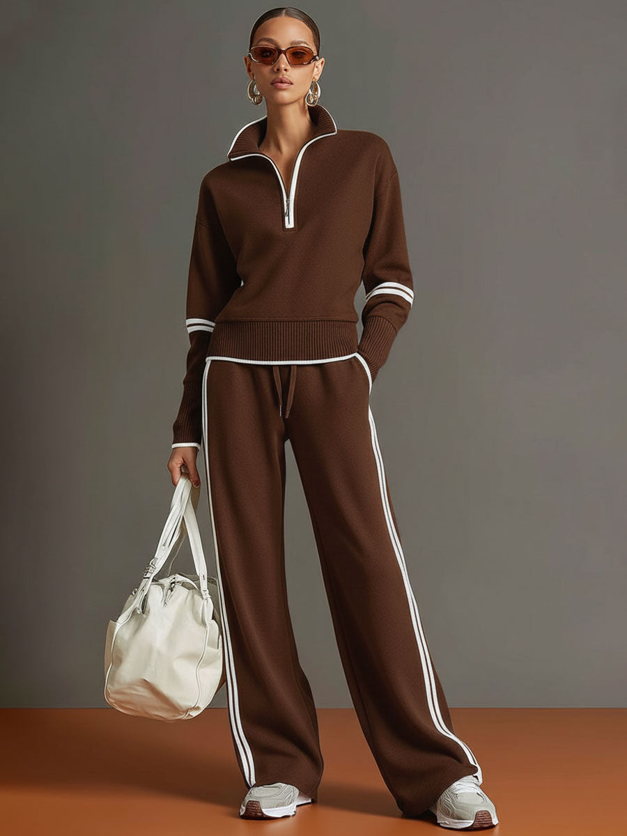 Sudadera gris y blanca de media cremallera con estilo vintage, acompañada de pantalones amplios