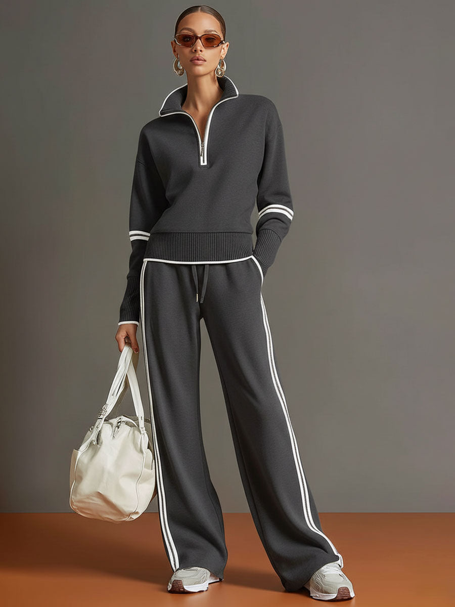 Sudadera gris y blanca de media cremallera con estilo vintage, acompañada de pantalones amplios